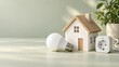 © Zygoun Studio - House Model with LED Bulb and Smart Plug on a Green Surface