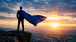 © PhotoArtHub - Man in suit with blue cape on cliff overlooking city at sunset, symbolizing success, leadership, and ambition