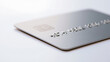 © twc - Close-up view of a blank metallic credit card on a clean white surface, showcasing modern banking, finance, and secure transaction concepts