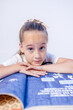 © Olga - Pretty 7 years old girl in black dress is posing in the photo studio with white background and blue light. This photo has been taken in Prague, Czech Republic, August 2026