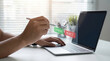 © Budi - Man hand holding stylus pointing at approve reject button document checklist hologram, representing digital workflow approval, business decision process and compliance technology concept