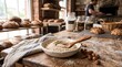 © Digital soul - Ground almond flour sitting in a ceramic bowl with a wooden spoon on a rustic wooden bakery table during production