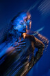 © ADDICTIVE STOCK - Woman portrait with motion blur and blue neon light