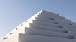 © AmDmLib - Geometric white building against a clear blue sky