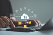 © MUNTHITA - Businessman hand using laptop computer with data host server storage icon for information exchange. Data transfer concept. Transfer data to a server or hosting service. File-sharing isometric. FTP.