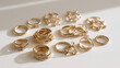© lnsu - Assorted Gold Rings and Jewelry Scattered on a White Surface