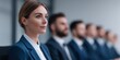 © Phanupong - Professional woman in business suit sitting with colleagues in modern office for corporate teamwork and business collaboration meeting session