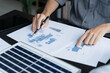 © Wanda - Electrical engineer working on solar panel blueprint sustainable energy