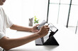 © Charlie's - Using stylus on tablet for digital note taking and productivity technology concept.