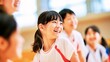 © Emi - Elementary school students smiling and talking (Physical education class, children in gym uniforms, school life)