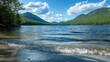 © Honey - Tranquil lake reflects majestic mountains, clear blue sky, and fluffy clouds, showcasing natural beauty and outdoor serenity