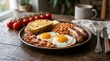 © Panuwat - Delicious full English breakfast with fried eggs, bacon, sausages, beans, and toast.
