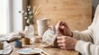 © Bay - Person painting a personalized ceramic mug at a wooden table