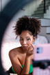 © Jovo Jovanovic/Stocksy - A woman applying makeup while filming a video tutorial