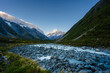© dachakrapan - Braided glacial river below Aoraki Mount Cook and a setting moon at dawn, New Zealand
