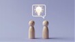 © joeycheung - Two wooden figures face each other, sharing a glowing lightbulb idea.
