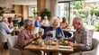 © Old Man Stocker - Joyful seniors enjoying a meal together in a bright dining area filled with plants and sunlight, showcasing friendship and community spirit at a care home.