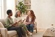 © spyrakot - Diverse midlife women enjoying conversation in cozy living room