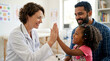© fibekti - Doctor giving high five to happy child patient, father smiling beside them
