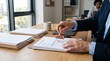 © SceneStockHub - Close up of businessman hand stamping approved seal on official document contract at wooden desk in bright modern office with paperwork and coffee mug