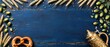 © Mongkol - Rustic blue wooden backdrop featuring beer stein pretzel hops celebrating oktoberfest festivities