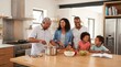 © Chandara - A family of four, consisting of a man, a woman, a boy, and a girl, is gathered in a kitchen, cooking together. The man is wearing a checkered shirt, the woman is wearing a denim jacket,