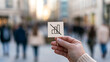 © A2Z AI  - A person hold a small sign with a crossed out bar chart symbol representing financial decline or economic crisis in a busy urban street scene