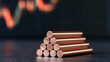 © A2Z AI  - Copper metal rod stock stack pyramid pile with financial market graph chart display on dark background for economy concept close up shot