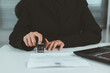 © Goodtime - Businesswoman validates and manages business documents and agreements, signing a business contract approval of contract documents confirmation or warranty certificate,approval stamp.