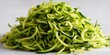 © Danang - Fresh spiralized zucchini noodles piled on a light white surface