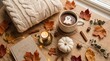 © Anastasia - Cozy autumn flat lay with a cup of hot cocoa, marshmallow ghost, knit sweater, book, and falling leaves on a wooden background