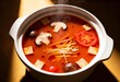 © SigmaCrew - Authentic steaming chinese hot pot soup with mushrooms sliced tomatoes tofu noodles, asian food