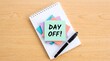 © Rashed - Day Off Sticky Note on Notebook with Marker Pen, Vacation Concept