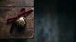 © Lexi - Antique brass jingle bell with red velvet ribbon on wooden surface
