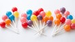 © Florence Poppy - Colorful lollipop collection featuring glossy red, blue, yellow, pink, purple, and orange candy pops on sticks, arranged in playful groups with soft highlights and shading.