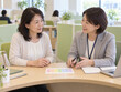 © NUMADAI STOCK - 子育て後の再就職について相談する中高年女性