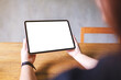 © Farknot Architect - Mockup image of a woman holding digital tablet with blank white desktop screen