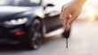 © Nart - A hand holds a car key in front of a modern, blurred vehicle with sunlight glinting off its glossy surface. Ultra-realistic shot highlighting car ownership and lifestyle.