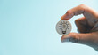 © Manasanan Wongchoomp - Hand holds a wooden token with a light bulb, brain, and circuit symbol, representing artificial intelligence, creative thinking, innovation, technology, knowledge, learning, and digital solutions.