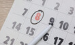 © splitov27 - Paper calendar on the table with the number 8 circled.