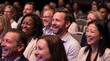 © Vera - Multiracial audience laughing during an event in a conference hall