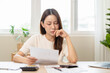 © Pormezz - person using calculator calculating tax refund on the table