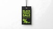© Jamina - A single black rectangular price tag hanging against a plain white background announcing a special black friday sale event with green text and percentage symbol