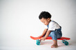© Rawpixel.com - Toddler joyfully riding skateboard indoors