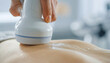© HumblePride - Aesthetic Treatment on Back: A close-up shows a hand holding a device performing a skin treatment on a person's back, focusing on the glow and care of the skin.