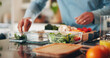 © peopleimages.com - Person, hands and chef with food containers in kitchen for healthy meal prep or ready made snack. Culinary artists, vegetables or vegetarian ingredients for diet, wellness or eating plan in home