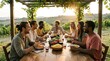 © Azril - Diverse group of friends enjoying a communal dinner party at a vineyard during sunset.