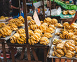 © mariamontoyart - Ripe Yellow Bananas for Sale at an Outdoor Market
