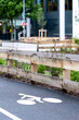 © yaqui_villegas - Urban bicycle lane with white cycling symbol beside roadside barrier and greenery showing city mobility infrastructure in an everyday transport setting