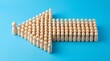 © Mohammad - Wooden peg figures arranged in arrow shape, leadership and teamwork concept on blue background, group of people following a leader